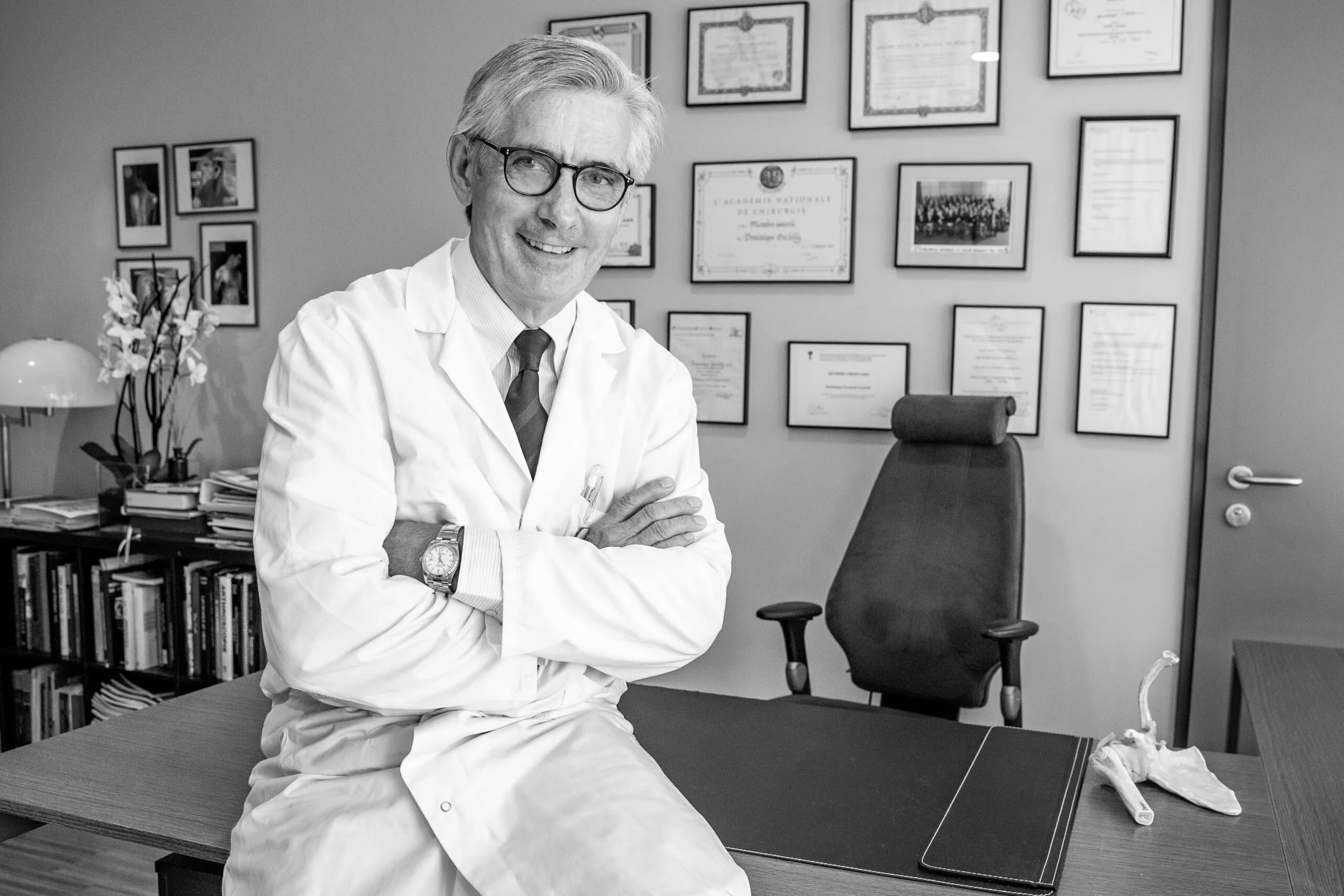 Dr Dominique-François Gazielly in his practice, surrounded by his diplomas